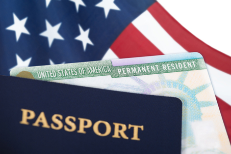 Green Card alongside a U.S. passport
