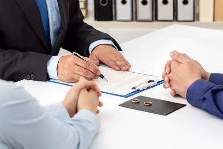 A couple meeting with an attorney at a table