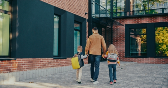 Father walking children into school