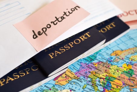 passport with deportation sticky note